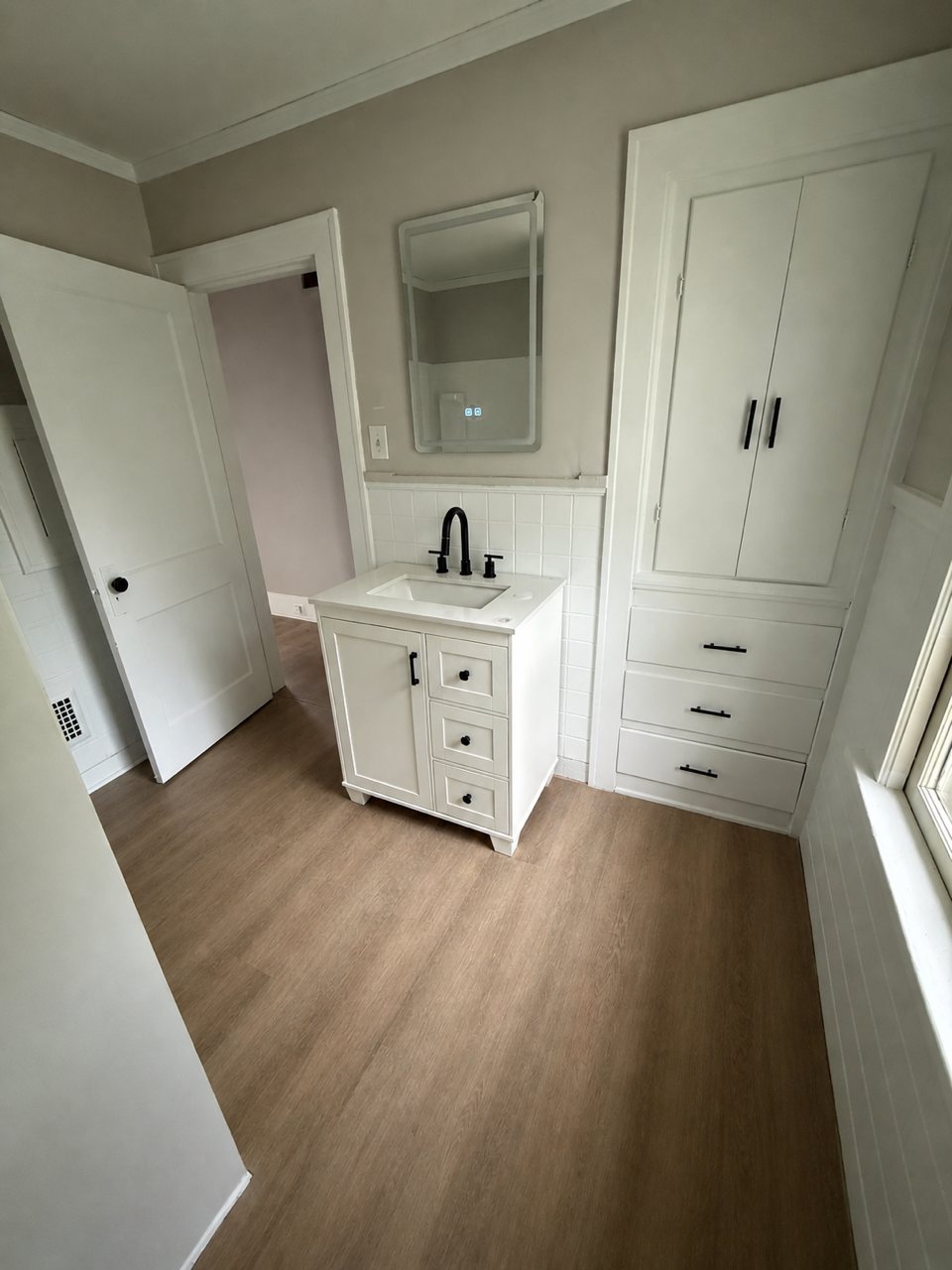 Finished bathroom vanity with black fixtures