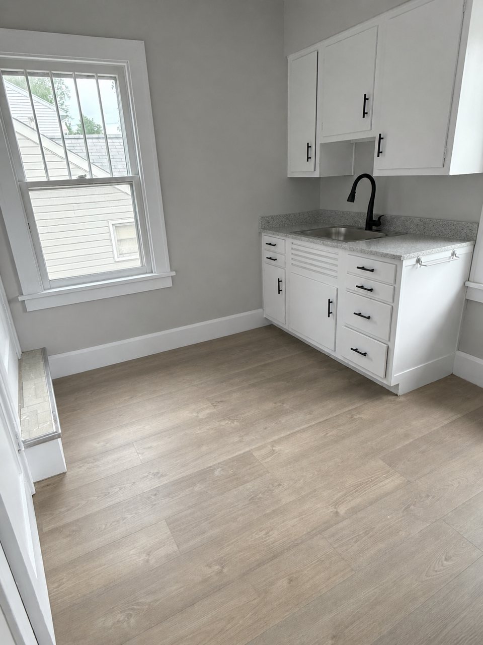 Finished compact kitchen with white cabinetry