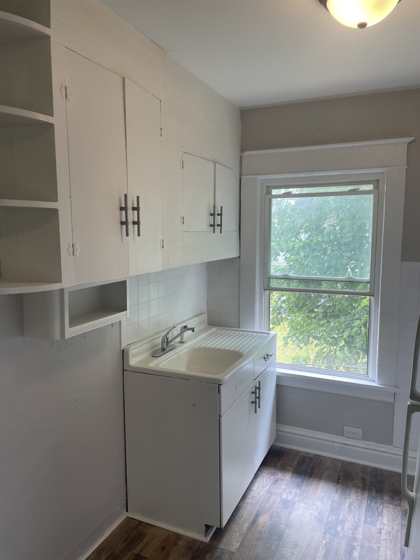 Finished compact kitchen with warm wood-look flooring