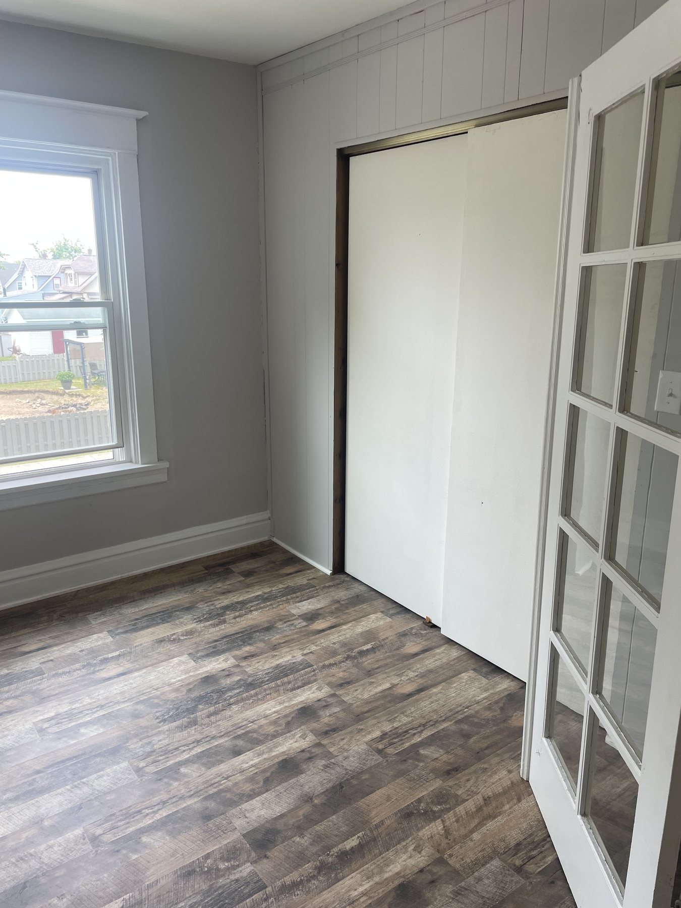 Finished bedroom with warm wood-look flooring