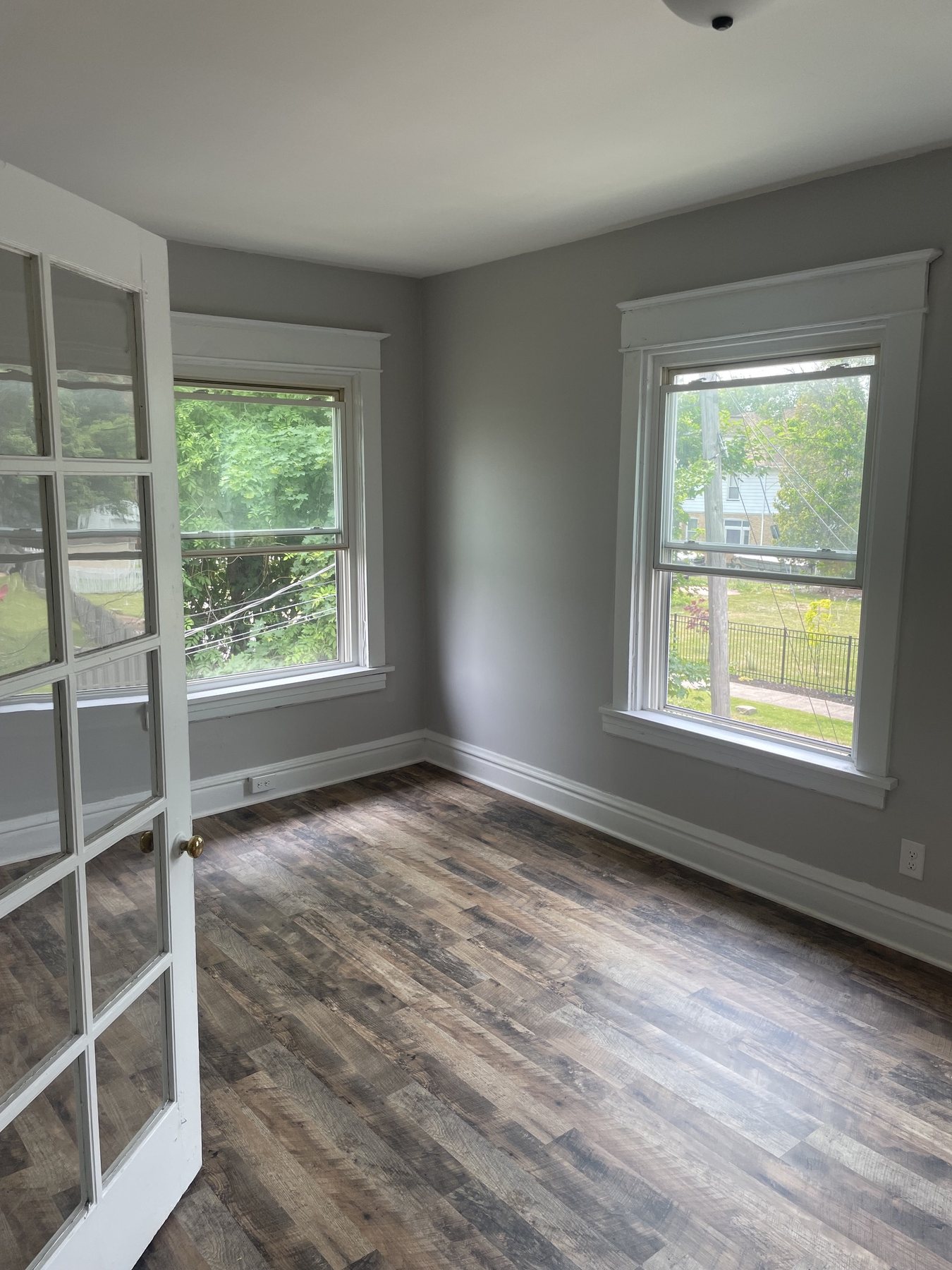 Finished room with French doors and warm flooring