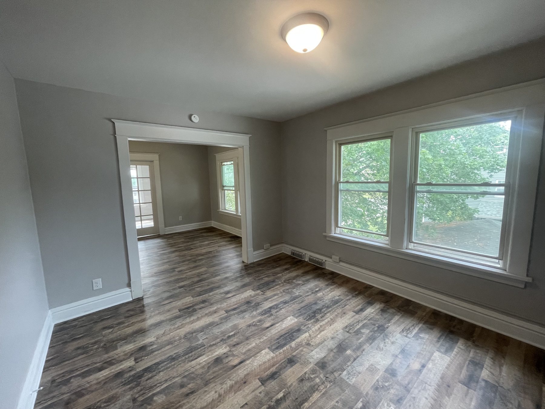 Finished corner living room with gray walls