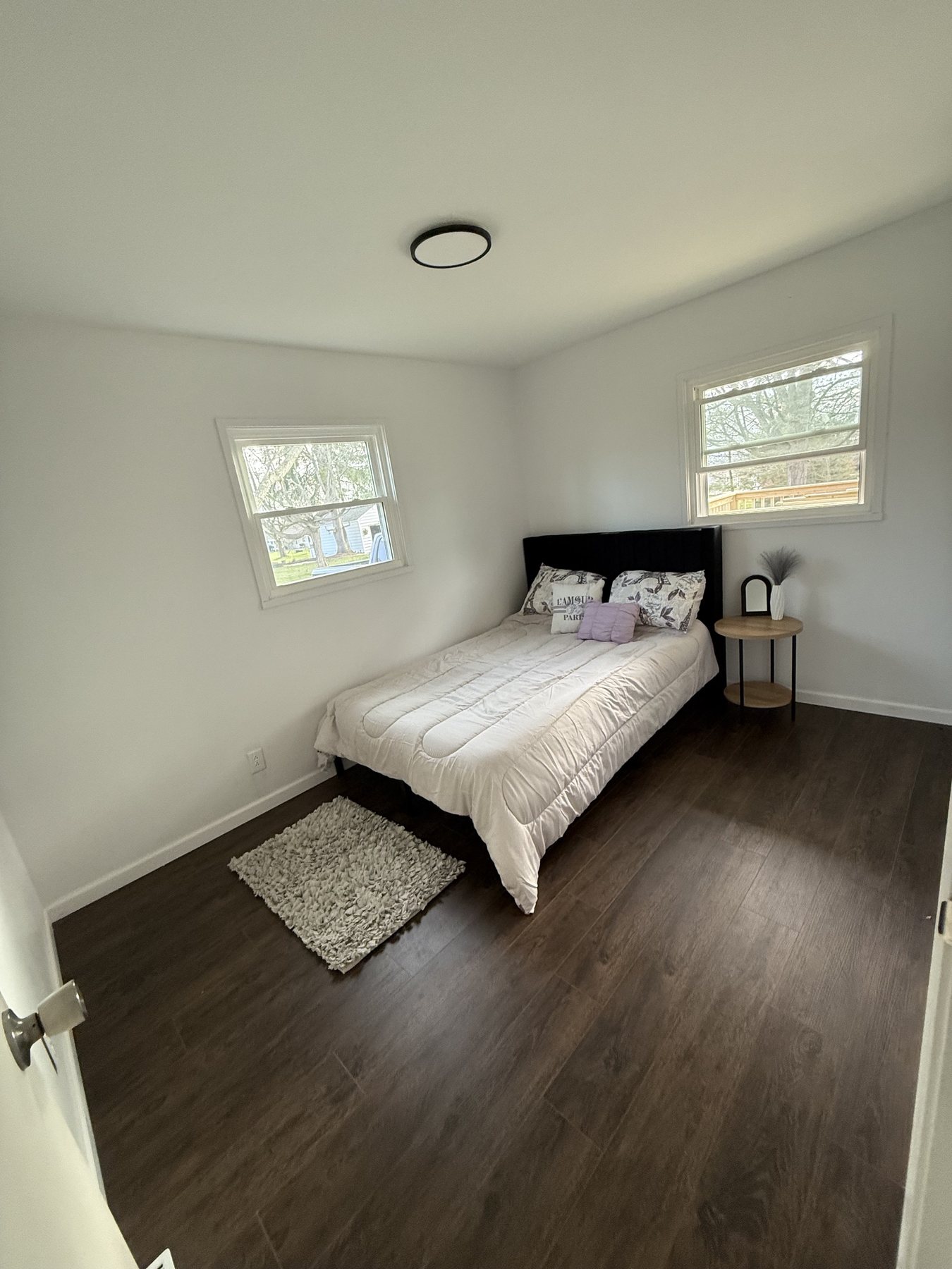 Staged bedroom with dark flooring after the refresh
