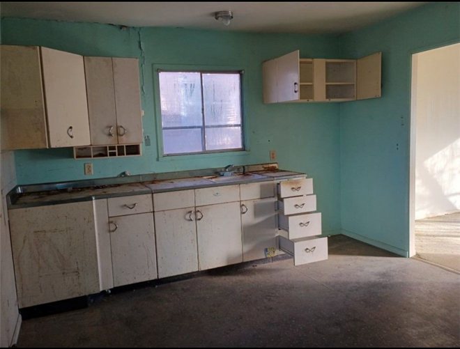 Dated turquoise kitchen before the rental refresh